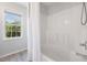 Bathroom featuring a tub, shower, and natural light from window at 401 Onondaga Ct, Holly Springs, NC 27540