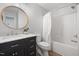 Bathroom featuring a modern vanity with a round mirror and combined bath and shower at 401 Onondaga Ct, Holly Springs, NC 27540