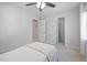 This bedroom is roomy and features neutral walls and a ceiling fan with attached lighting at 401 Onondaga Ct, Holly Springs, NC 27540