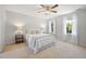 Cozy bedroom with neutral tones, ceiling fan, carpet flooring, with bright, natural light at 401 Onondaga Ct, Holly Springs, NC 27540