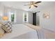 Bedroom featuring a ceiling fan, light colored carpet, and closet with sliding barn door at 401 Onondaga Ct, Holly Springs, NC 27540