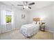 This bright bedroom showcases a large window with white curtains and a decorative headboard at 401 Onondaga Ct, Holly Springs, NC 27540