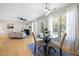 Sunlit dining area showcasing hardwood floors, large windows, and modern lighting at 401 Onondaga Ct, Holly Springs, NC 27540