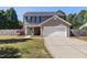 Charming two-story home features a teal front door and well-maintained lawn at 401 Onondaga Ct, Holly Springs, NC 27540