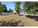 Well-maintained front yard featuring a lush lawn, mature trees, and a charming home exterior with a white garage door at 401 Onondaga Ct, Holly Springs, NC 27540