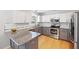 Bright kitchen features granite counters, stainless appliances, white subway tile and gray and white cabinets at 401 Onondaga Ct, Holly Springs, NC 27540