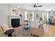 Bright living room features a fireplace, hardwood floors and a ceiling fan at 401 Onondaga Ct, Holly Springs, NC 27540