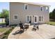 Spacious back patio area with a stone fire pit and seating, perfect for outdoor entertaining at 401 Onondaga Ct, Holly Springs, NC 27540