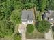 Aerial view of a residential property showcasing its location, landscaping, and surrounding trees at 408 Blooming Meadows Rd, Holly Springs, NC 27540