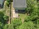 Aerial view of the home showcasing the backyard patio with fire pit and surrounding landscaping at 408 Blooming Meadows Rd, Holly Springs, NC 27540