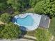 Community pool featuring a unique shape, surrounded by trees and lounge chairs at 408 Blooming Meadows Rd, Holly Springs, NC 27540