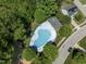 Aerial view of the community pool, playground, and surrounding neighborhood at 408 Blooming Meadows Rd, Holly Springs, NC 27540