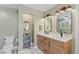 Bathroom featuring double sinks, wood cabinets, and neutral walls at 408 Blooming Meadows Rd, Holly Springs, NC 27540
