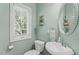 Cozy bathroom with a sink, toilet, and window at 408 Blooming Meadows Rd, Holly Springs, NC 27540