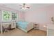 Bedroom features a twin bed, large window and neutral walls at 408 Blooming Meadows Rd, Holly Springs, NC 27540