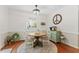 Comfortable dining area with a peace sign, wooden table, natural lighting, and hardwood floors at 408 Blooming Meadows Rd, Holly Springs, NC 27540