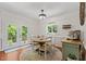 Charming dining area featuring a round wooden table, natural lighting, and access to the backyard at 408 Blooming Meadows Rd, Holly Springs, NC 27540