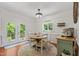 Cozy dining room with a round table, French doors, and view of the outdoor scenery at 408 Blooming Meadows Rd, Holly Springs, NC 27540