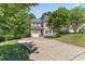 Two-story home with attached garage and extended driveway at 408 Blooming Meadows Rd, Holly Springs, NC 27540