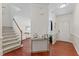 Elegant foyer with hardwood floors, white walls, and staircase at 408 Blooming Meadows Rd, Holly Springs, NC 27540