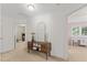 Bright hallway with views into bedrooms and a decorative cabinet at 408 Blooming Meadows Rd, Holly Springs, NC 27540