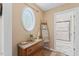 Hallway featuring decor, unique window and doorway to a full bathroom at 408 Blooming Meadows Rd, Holly Springs, NC 27540
