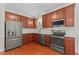 Modern kitchen with stainless steel appliances, wooden cabinets, and white countertop at 408 Blooming Meadows Rd, Holly Springs, NC 27540
