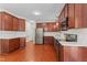 Spacious kitchen featuring stainless steel appliances, hardwood floors, and custom cabinetry at 408 Blooming Meadows Rd, Holly Springs, NC 27540