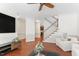 Bright living room boasts hardwood floors, and a beautiful staircase at 408 Blooming Meadows Rd, Holly Springs, NC 27540