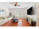 Comfortable living room featuring hardwood floors, modern decor, and plenty of seating space at 408 Blooming Meadows Rd, Holly Springs, NC 27540