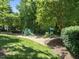 Community playground surrounded by trees, offering fun and safe recreational activities at 408 Blooming Meadows Rd, Holly Springs, NC 27540