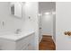 Bathroom vanity with chrome faucet, mirror and view to hall at 430 Fenton St, Raleigh, NC 27604