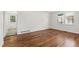 Bright bedroom with gleaming hardwood floors, white walls, and two windows providing natural light at 430 Fenton St, Raleigh, NC 27604