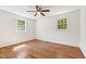 Bright bedroom with hardwood floors, white walls, ceiling fan, and a window at 430 Fenton St, Raleigh, NC 27604