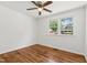 Bright bedroom featuring hardwood floors, a ceiling fan, and windows with green outdoor views at 430 Fenton St, Raleigh, NC 27604
