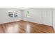 Bright room with hardwood floors, white walls, and natural light streaming through two windows at 430 Fenton St, Raleigh, NC 27604