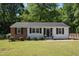 Charming single-story home featuring a combination of brick and white siding and a well-maintained front lawn at 430 Fenton St, Raleigh, NC 27604