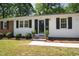 Inviting front entrance with a black door, symmetrical potted plants, and a well-manicured lawn at 430 Fenton St, Raleigh, NC 27604
