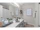 Bright bathroom featuring a single sink vanity, decorative shelving, and a framed print at 4535 Sugarbend Way, Raleigh, NC 27606