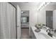 Bright bathroom with a connecting doorway to a bedroom featuring a shower with patterned shower curtain at 4535 Sugarbend Way, Raleigh, NC 27606