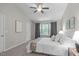 Spacious bedroom featuring a large window, ceiling fan, and plush carpeting at 4535 Sugarbend Way, Raleigh, NC 27606