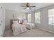 Bedroom featuring two twin beds with patterned bedspreads and neutral walls with two windows at 4535 Sugarbend Way, Raleigh, NC 27606