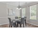 Cozy dining room with an elegant chandelier, neutral walls, and hardwood flooring at 4535 Sugarbend Way, Raleigh, NC 27606