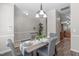 Inviting dining space with a chandelier, a hardwood floor, and a seamless transition to the kitchen at 4535 Sugarbend Way, Raleigh, NC 27606