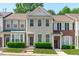 Inviting townhouse facade featuring neutral siding, complemented by manicured greenery and a welcoming entrance at 4535 Sugarbend Way, Raleigh, NC 27606