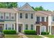 Charming townhouse with light siding, complemented by lush green bushes and a well-manicured lawn at 4535 Sugarbend Way, Raleigh, NC 27606