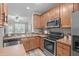 Well-lit kitchen with wooden cabinetry, stainless steel appliances, and a seamless connection to the living area at 4535 Sugarbend Way, Raleigh, NC 27606