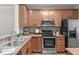Functional kitchen with wooden cabinets, stainless steel appliances, and ample counter space for meal preparation at 4535 Sugarbend Way, Raleigh, NC 27606