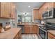 Functional kitchen featuring wooden cabinets, stainless steel appliances, and an open view to the living area at 4535 Sugarbend Way, Raleigh, NC 27606