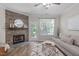 Comfortable living room featuring a stone fireplace, stylish rug, and neutral color palette at 4535 Sugarbend Way, Raleigh, NC 27606